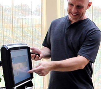 Person using a touch screen communication aid