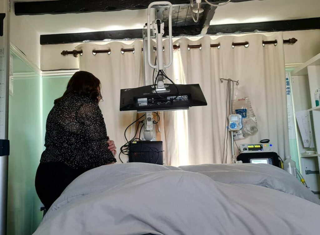 Hospital wall mount in use above the user's bed