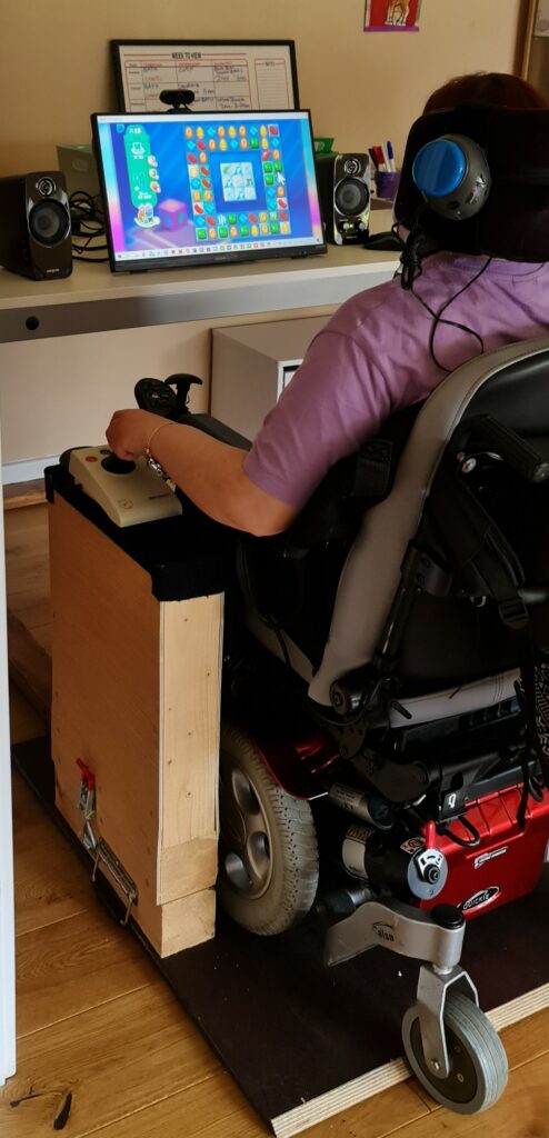 A floor mounted joystick being used with a computer