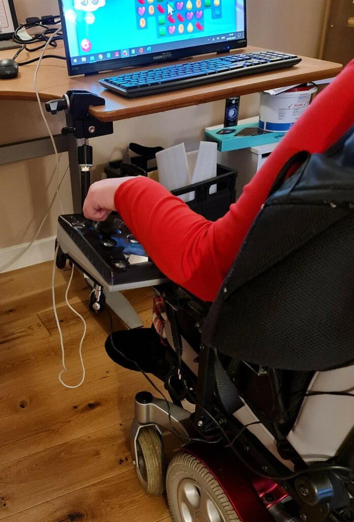 A person using a wheelchair mounted joystick